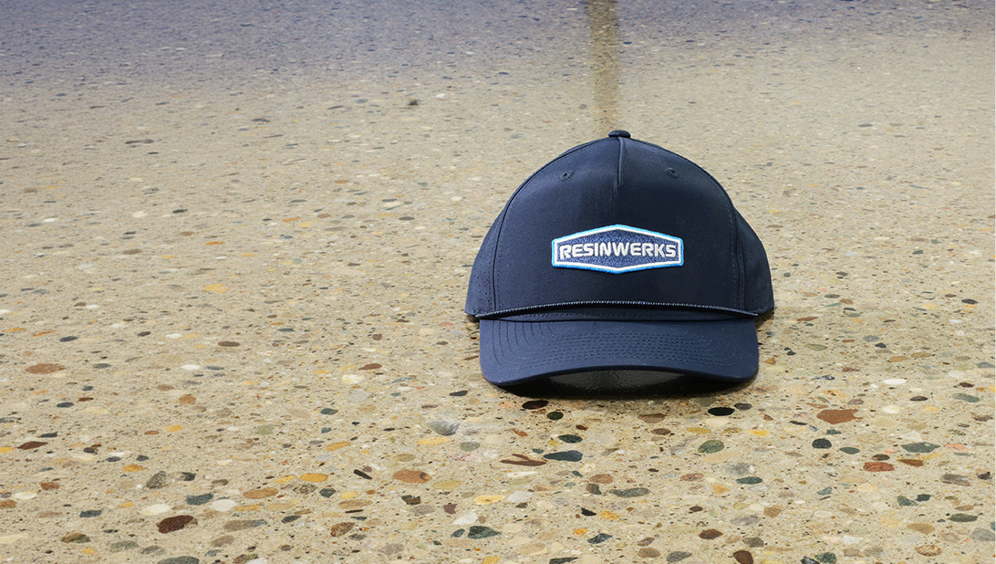 navy Resinwerks baseball cap on polished concrete floor