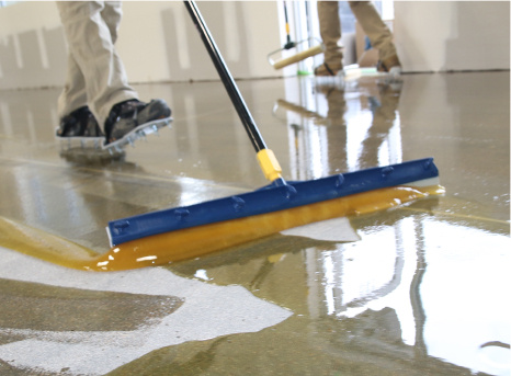 Photo of concrete floor coating contractors installing a coating